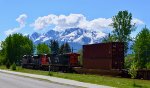 CN 8962/2568 lead a unit stack train S/B through Valemount, with the Cariboo Range Mtns., in the background